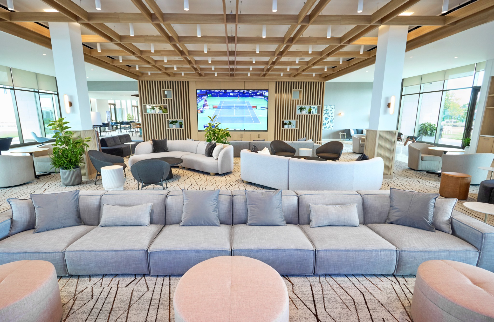 large suite with varied seating and a large television