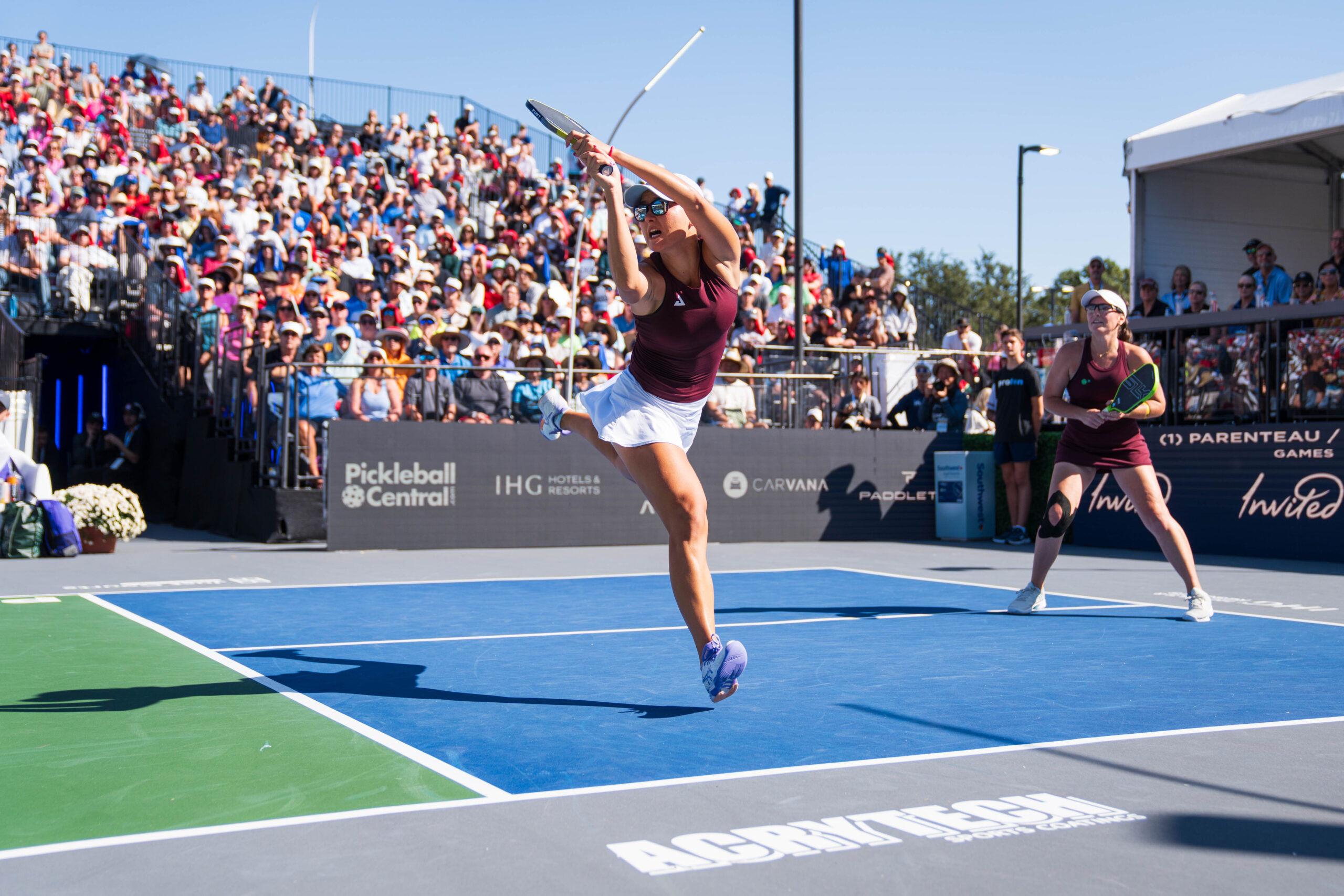 doubles tennis team returning a serve