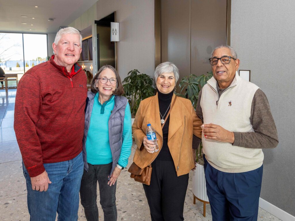 Group of people smiling at the camera in the Cincinnati Open Sporting Club