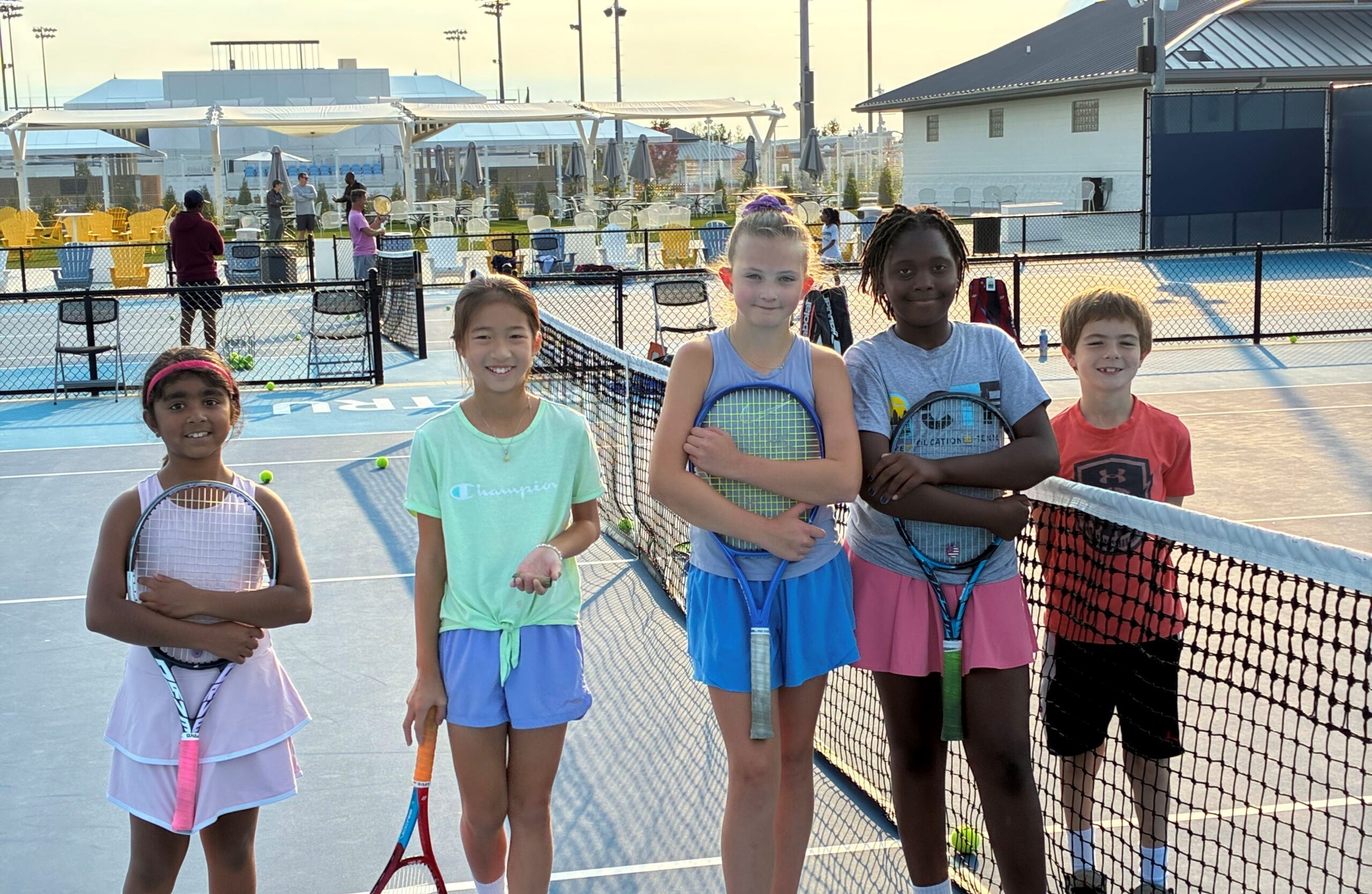 Summer camp participants on the tennis courts at Cincinnati Open Sporting Club