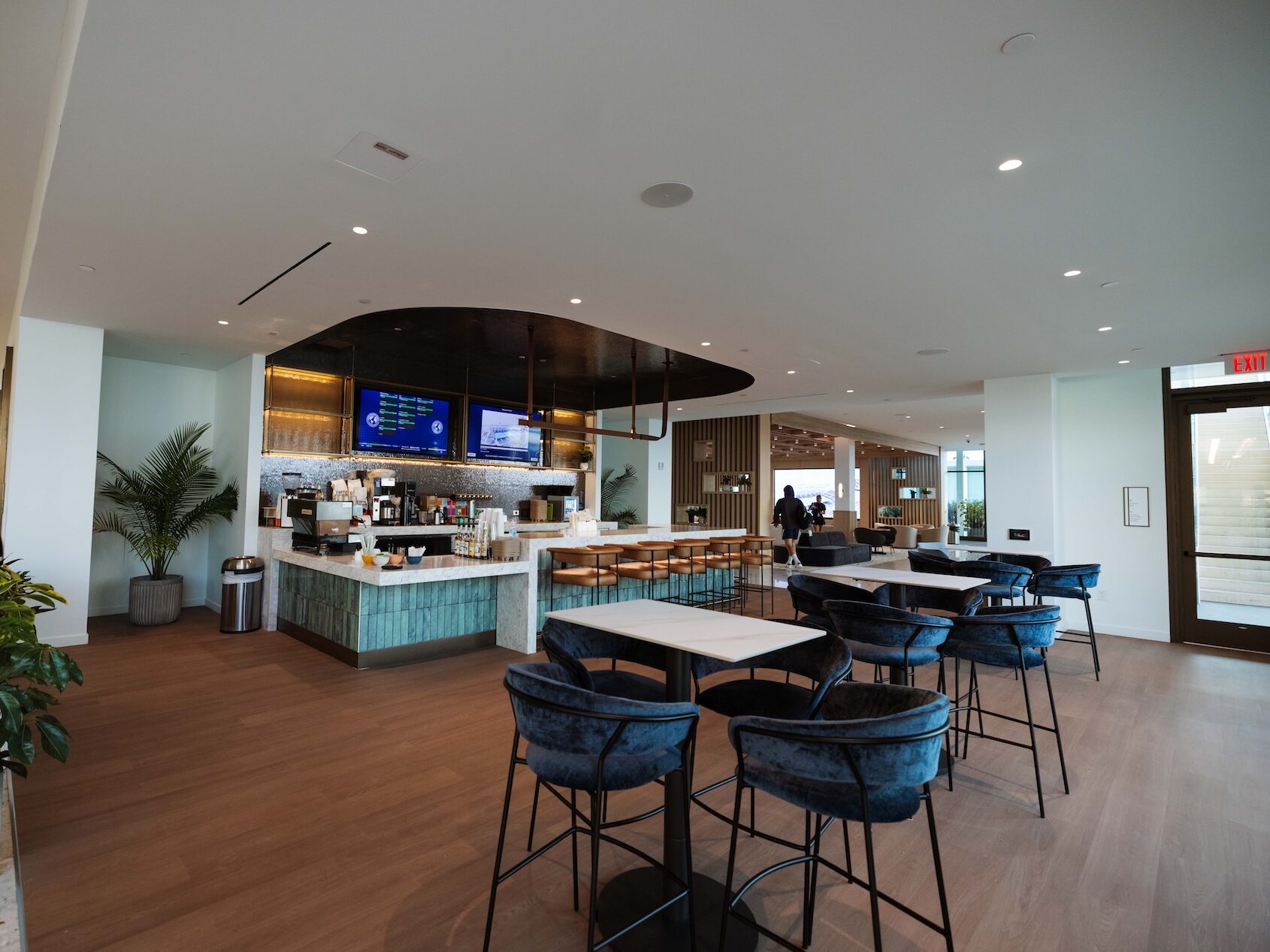 large room with cafe, tables and chairs for guest seating