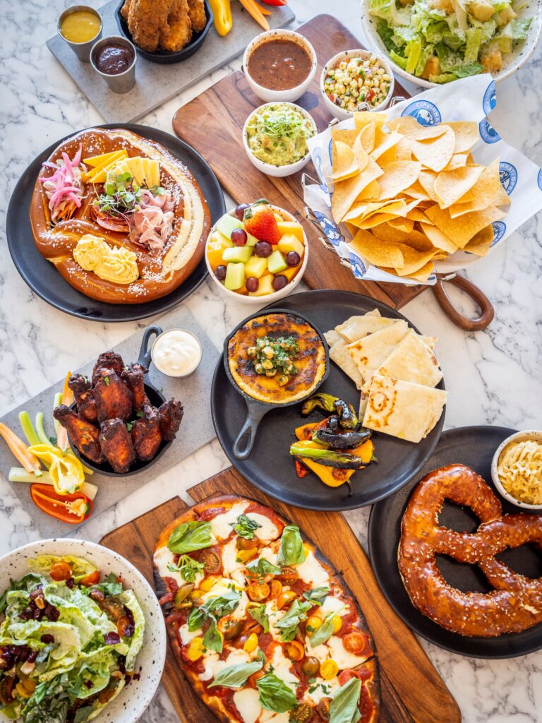 assortment of plates of food laid out on table