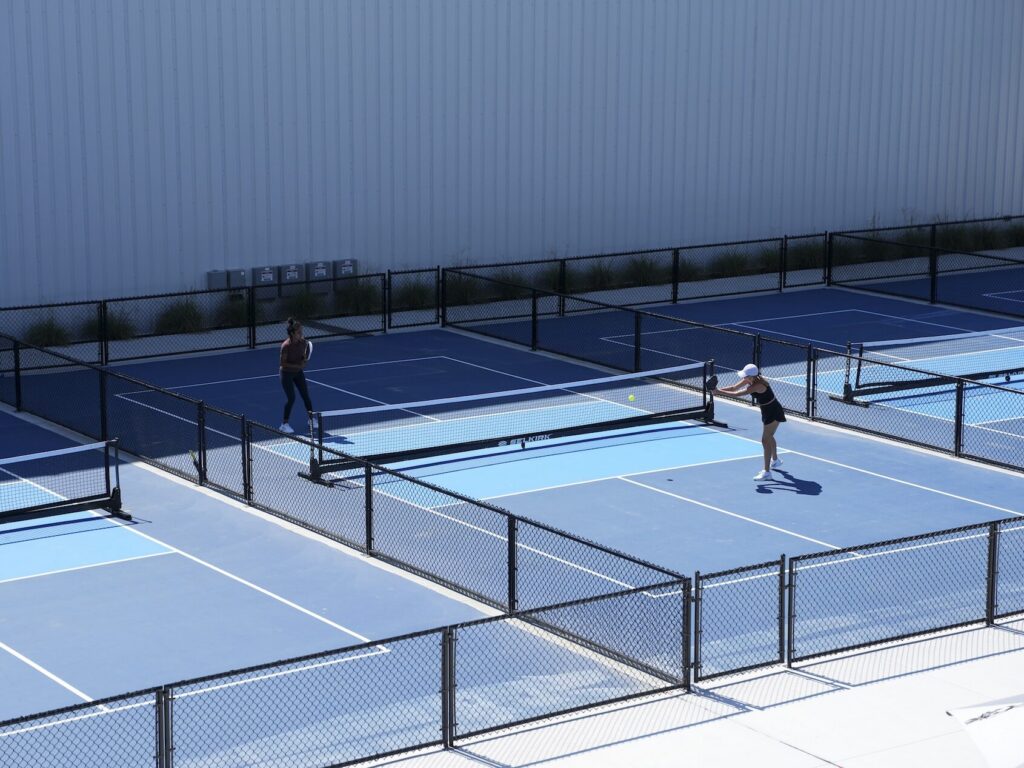 Two people playing on a pickleball court